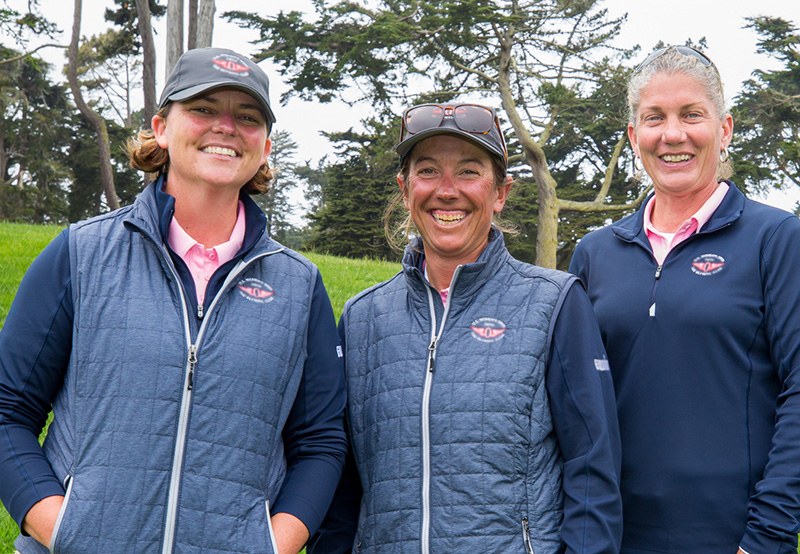 Three female tournament volunteers at the U.S. Women's Open