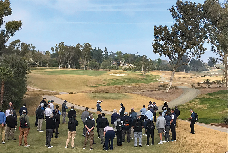 outdoor shot of a group standing on a golf course