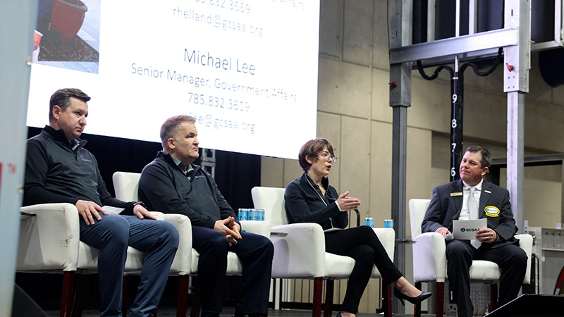 Four people sitting on a stage