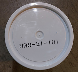 lid of a bucket of bentgrass seed with grower information written on it