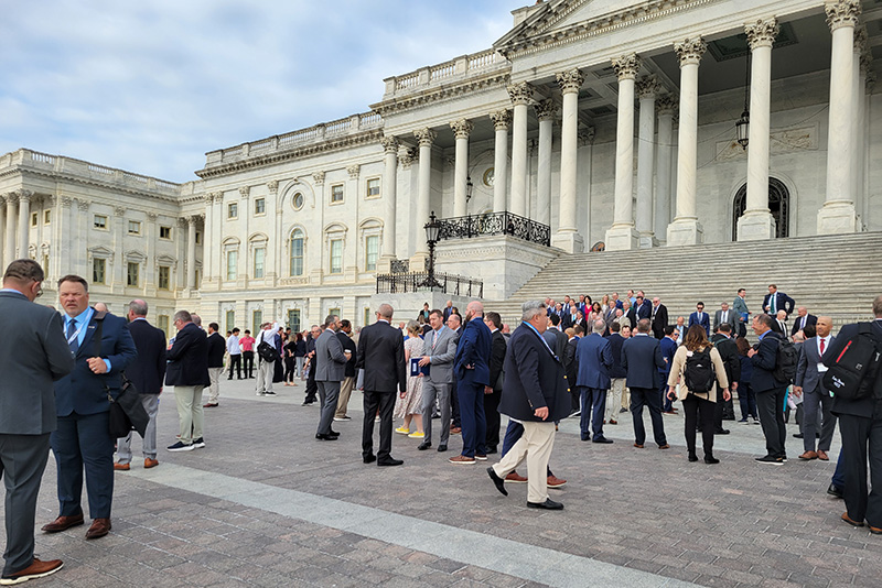 A group of people walking around the U.S. Capitol Building