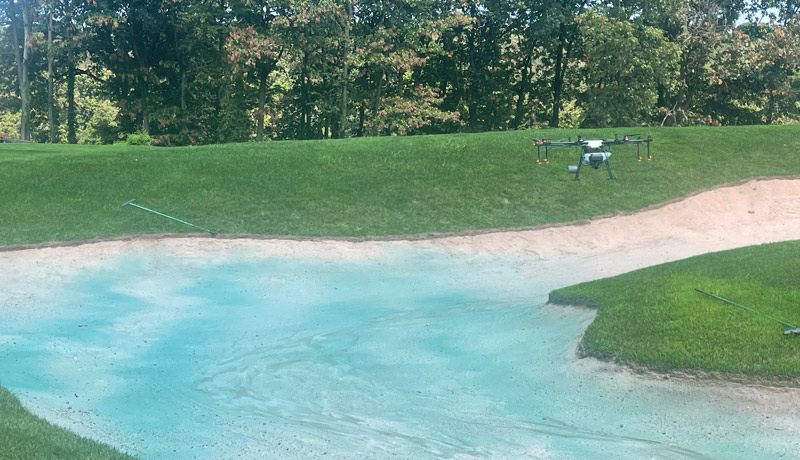 Drone spraying golf course