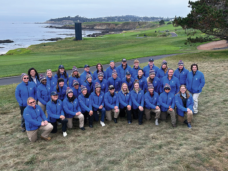 A group shot of women volunteers wearing blue polo shirt uniforms