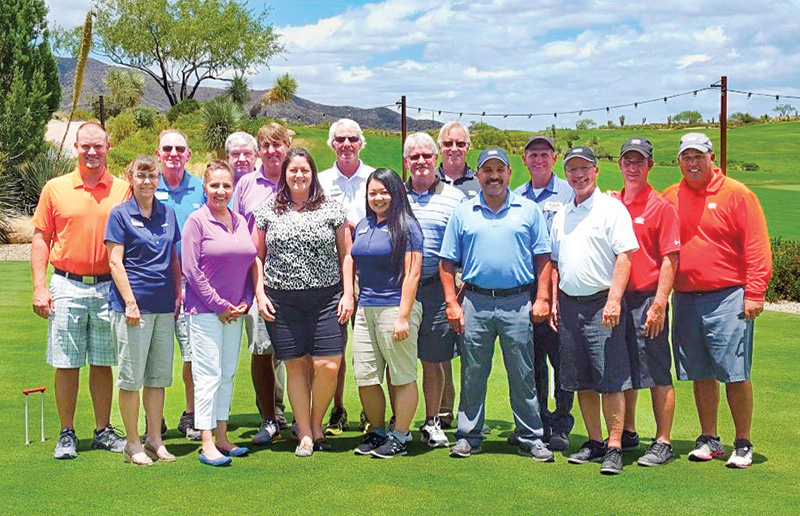 Emerson and team group photo outdoors at Desert Mountain golf course