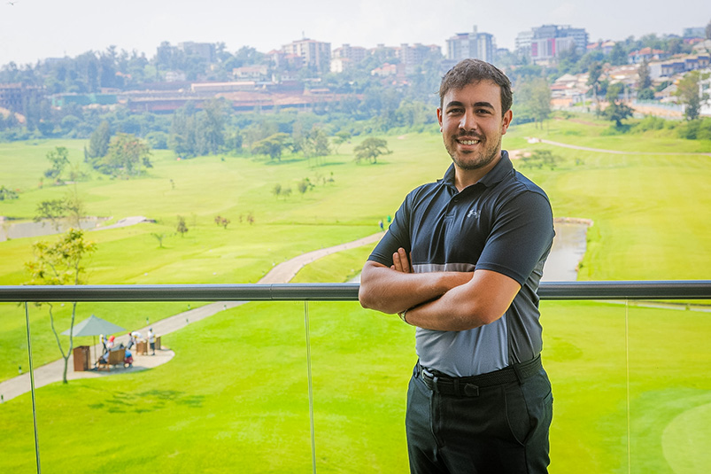 Man standing with golf course in the background