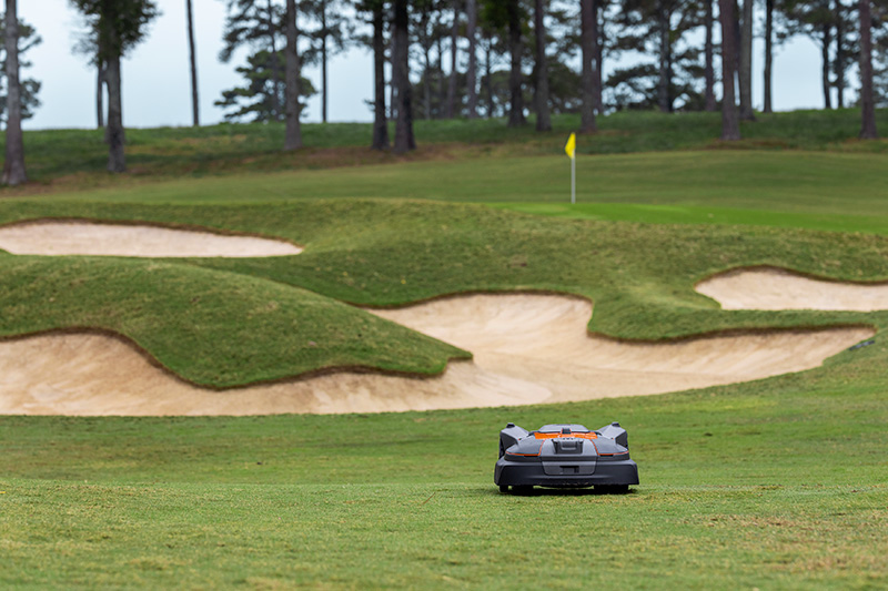 orange and black Husqvarna autonomous mower