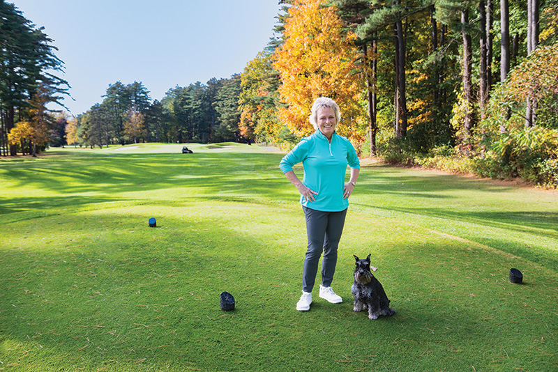 Dottie Pepper on a golf course with her dog Rupert