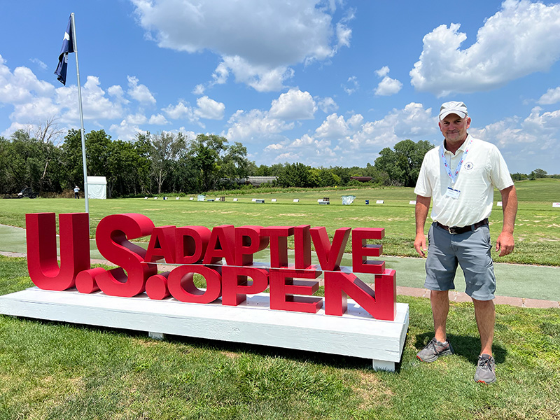 James Houchen with the U.S. Adaptive Open sign