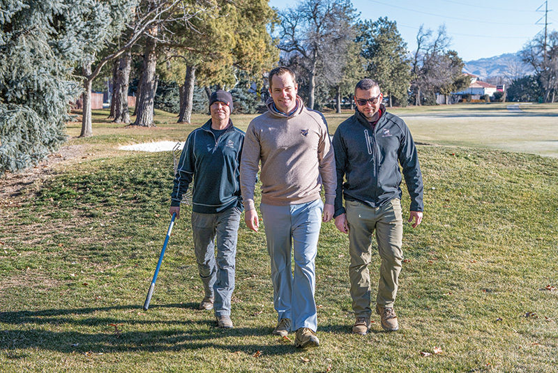 Three men working outdoors
