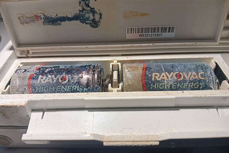 A pair of leaking alkaline batteries