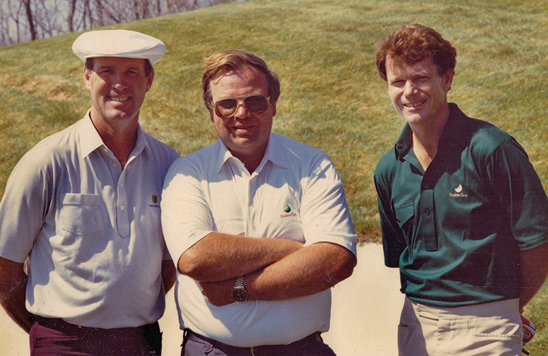 Three men standing together in 1989